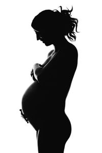 Side view of silhouette woman standing against white background