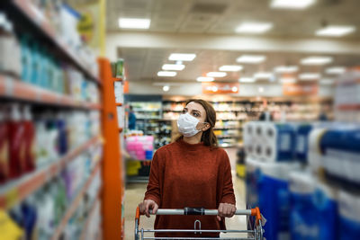 Woman wearing mask shopping at mall