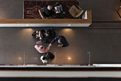 High angle view of people photographing in kitchen