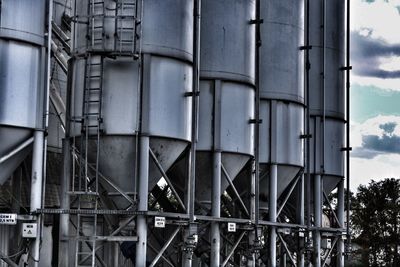 Low angle view of industry against sky