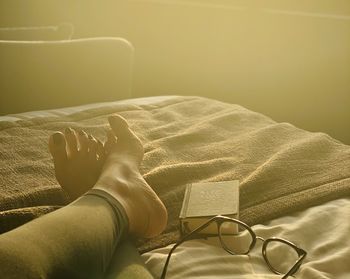 Low section of person lying on bed