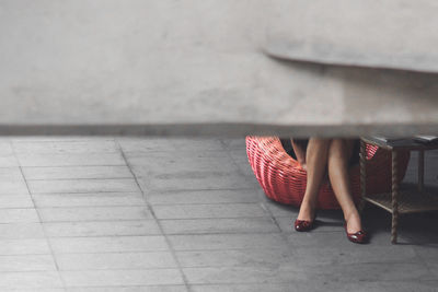 Low section of woman walking on floor