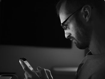 Man using mobile phone in darkroom