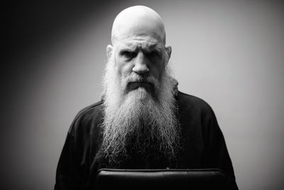 Portrait of man wearing hat against gray background