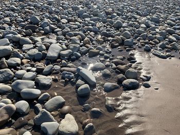Full frame shot of beach rocks sand water