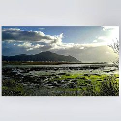 Scenic view of mountains against cloudy sky