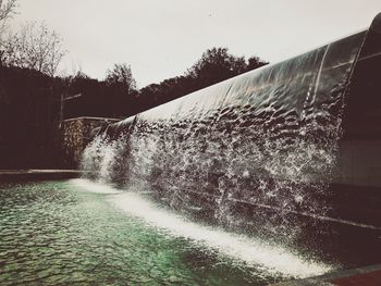 Blurred motion of waterfall against clear sky