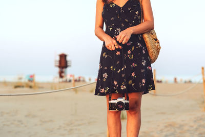 Woman with a vintage camera on the beach