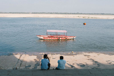 High angle view of people sitting on beach