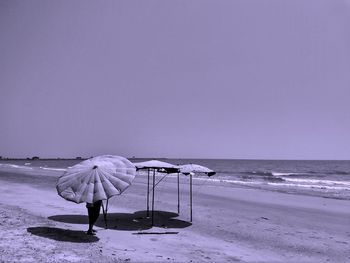 Umbrella on beach against clear sky