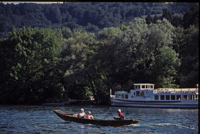 People on boat against trees