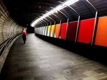 Rear view of man walking in subway station