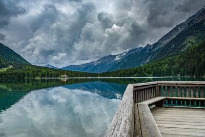 Scenic view of lake by mountains against sky