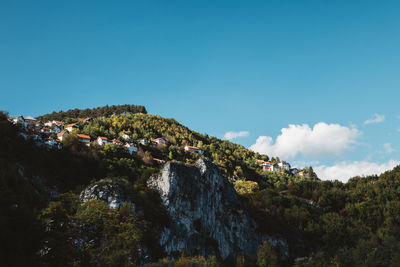 Scenic view of mountains against blue sky