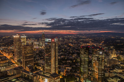 Aerial view of city lit up at sunset