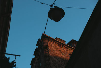 Low angle view of buildings against clear blue sky