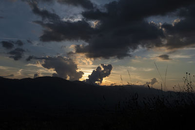 Scenic view of silhouette field against sky during sunset