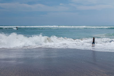 Full length of girl walking on shore at beach