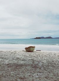 Boat on beach against sky