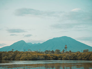 Scenic view of lake and mountains against sky