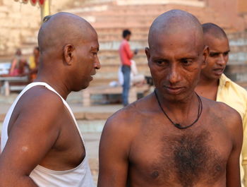 Portrait of shirtless man standing outdoors