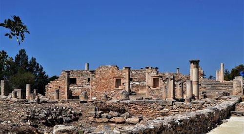 Old buildings against clear blue sky