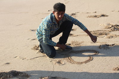 High angle view of man on beach during sunny day