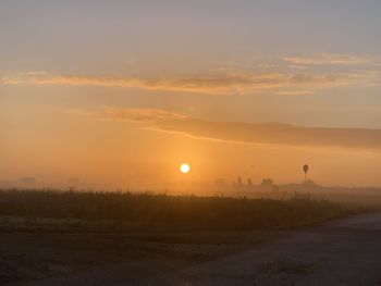 Scenic view of field against sky during sunset