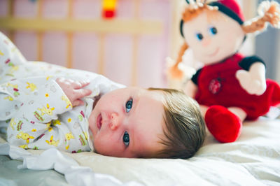 Portrait of cute baby boy sleeping on bed at home