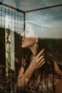 Portrait of woman with arms raised