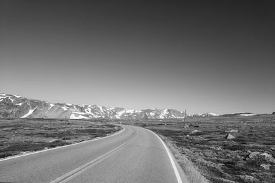 Empty road along countryside landscape