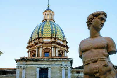 Low angle view of statue of temple against sky