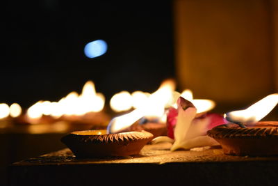 Close-up of burning candles on cake