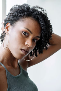 Portrait of a beautiful black woman with curly hair on a white background