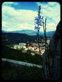 Scenic view of mountains against cloudy sky