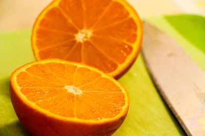 Close-up of halved orange fruit on table