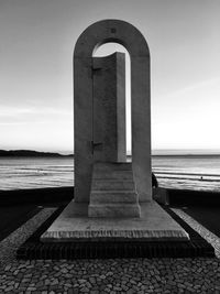 Built structure on beach against sky