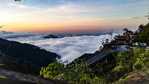 High angle view of trees and buildings against sky during sunset