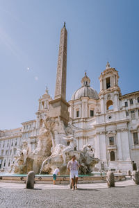 Man standing against building