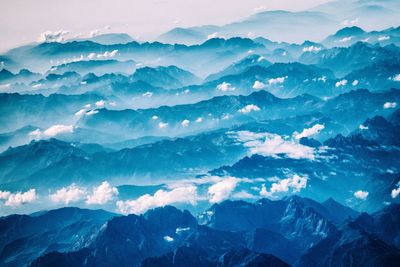 Aerial view of snowcapped mountains against sky