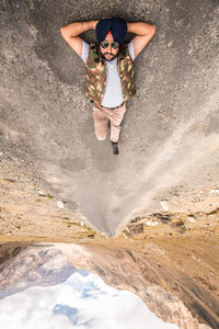 High angle view of man lying on road against sky