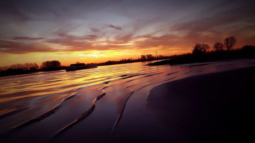 Scenic view of beach against sky during sunset