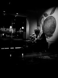 Young woman on table at night