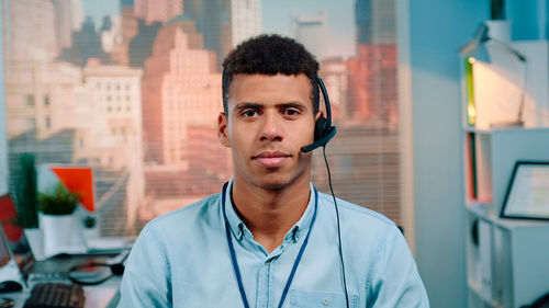 Portrait of young man standing in city