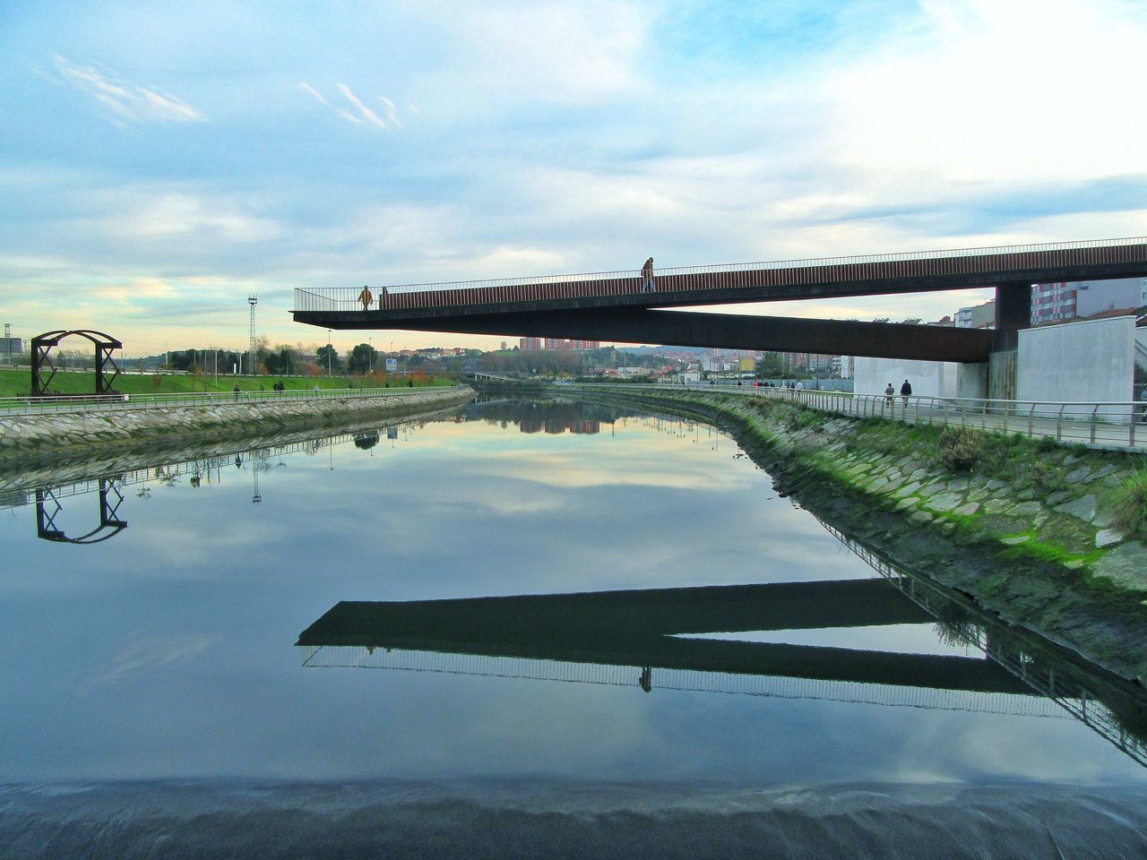 REFLECTION OF SKY ON WATER IN PARK AGAINST THE BACKGROUND