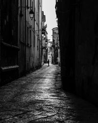 Narrow street amidst buildings in city