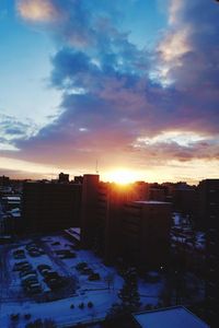 Buildings against sky during sunset in city