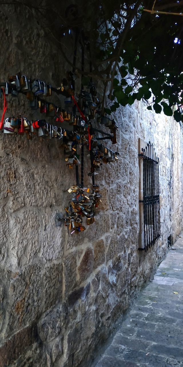 architecture, built structure, nature, water, day, no people, wall - building feature, building exterior, wall, outdoors, plant, tree, stone wall, railing, security, building, high angle view, solid, street, flowing water