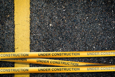 High angle view of yellow sign on road