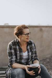 Smiling woman having coffee